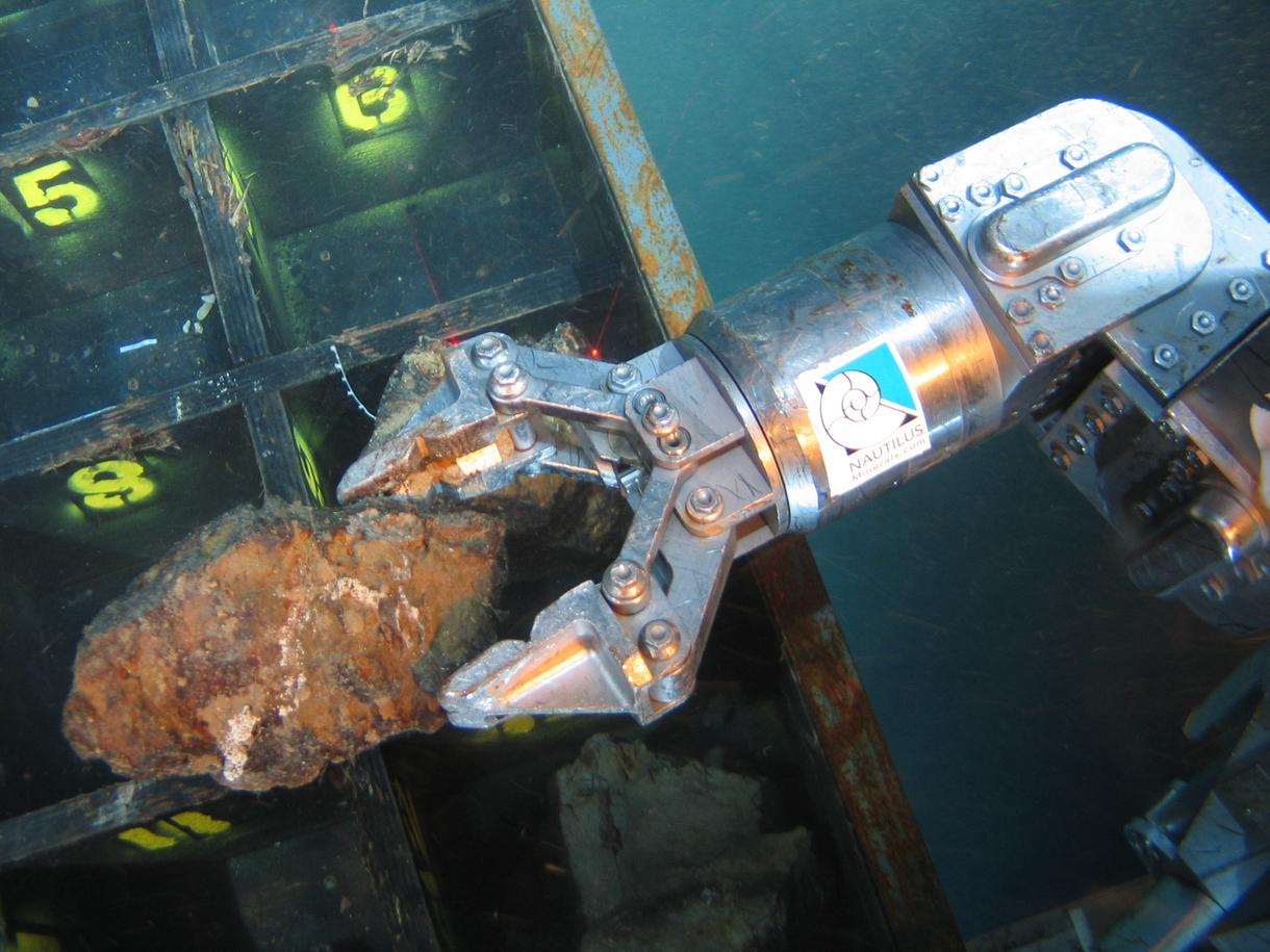 A robotic arm grabs a sample during an exploration cruise in the Bismarck Sea, in Papua New Guinea. (Credit: Nautilus) 