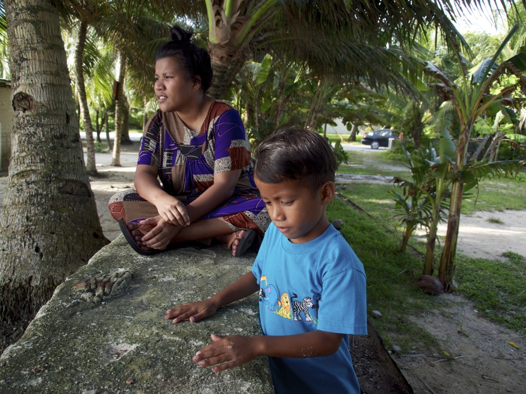 Sarah and her brother Josa outside her boyfriend’s parents’ house in Rairok, a village just outside the Marshall Islands’ capital of Majuro. (Credit: Krista Langlois)