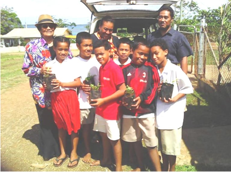 More students with their sandalwood plants and Tonga Trust director Mrs Papiloa Foliaki. Photo: TCDT/Nuku’alofa Times
