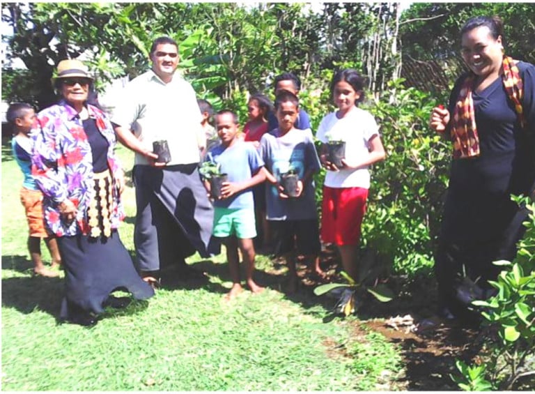 Mr Soane Lavakei’aho, 4CA teacher in Toula, with his students and Mrs Papiloa Foliaki showing the sandalwood plants that are being planted at the school. Photo: TCDT/Nuku’alofa Times